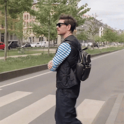 Man In Sunglasses And Black Backpack Crossing Street GIF