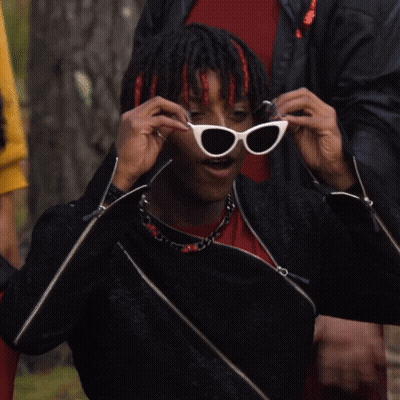Man In Sunglasses And Black Jacket Adjusting Glasses GIF