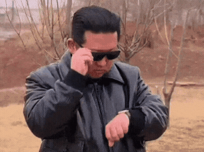 Man In Sunglasses And Black Jacket Checking Watch GIF