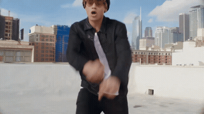 Man In Sunglasses And Black Jacket Dancing On Rooftop GIF
