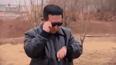Man In Sunglasses And Black Jacket Looking At Watch GIF