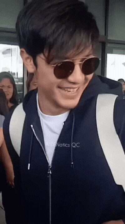 Man In Sunglasses And Black Jacket Smiles GIF