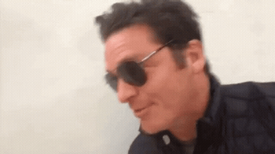 Man In Sunglasses And Black Jacket Smiling GIF