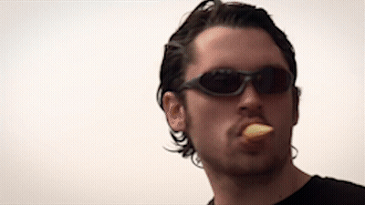 Man In Sunglasses And Black Shirt Eating GIF