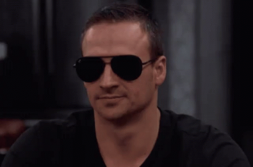 Man In Sunglasses And Black Shirt Looks Serious GIF