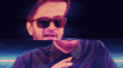 Man In Sunglasses And Black Shirt On Screen GIF