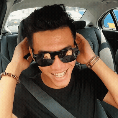 Man In Sunglasses And Black Shirt Smiling In Car GIF