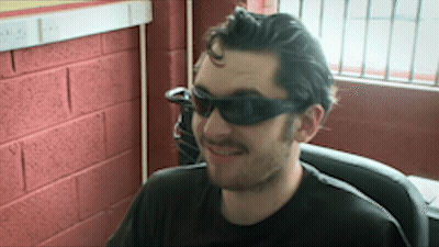 Man In Sunglasses And Black Shirt Smiling GIF