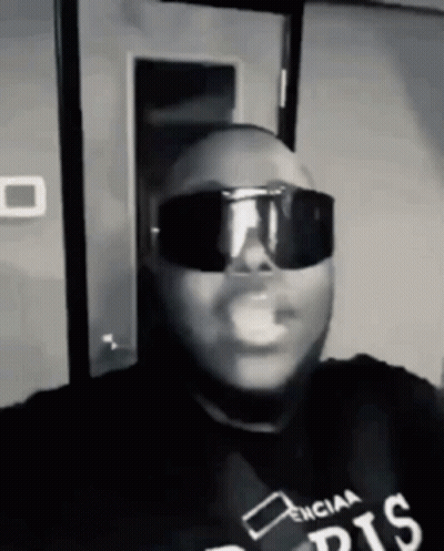 Man In Sunglasses And Black Shirt Smoking Black And White GIF