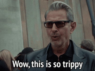 Man In Sunglasses And Black Suit Saying Wow This Is So Trippy GIF