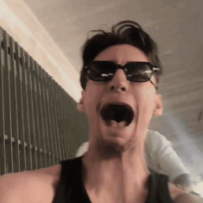Man In Sunglasses And Black Tank Top Making Funny Face GIF