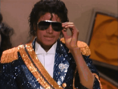 Man In Sunglasses And Blue Jacket With Gold Trim GIF