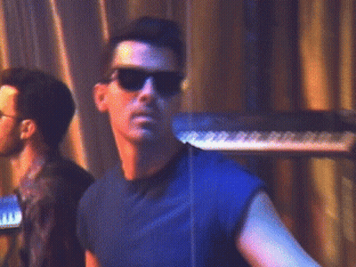 Man In Sunglasses And Blue Shirt At Keyboard GIF