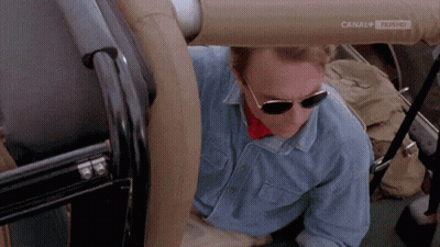 Man In Sunglasses And Blue Shirt In Car With Canal 4 Film HD GIF