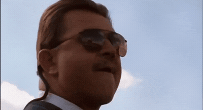 Man In Sunglasses And Earpiece Looking Up GIF