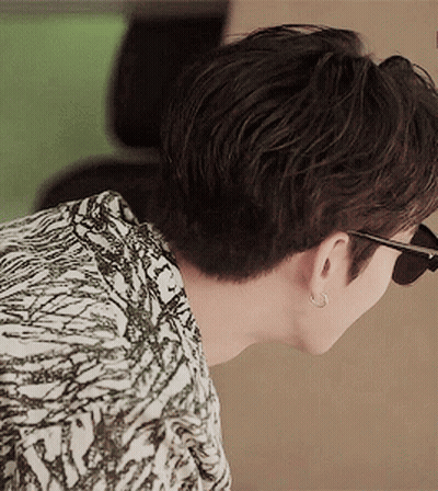 Man In Sunglasses And Earrings Looking Down GIF