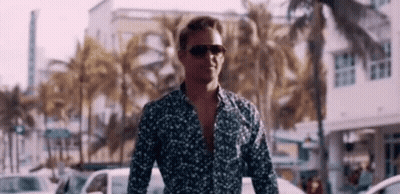 Man In Sunglasses And Floral Shirt Walking GIF
