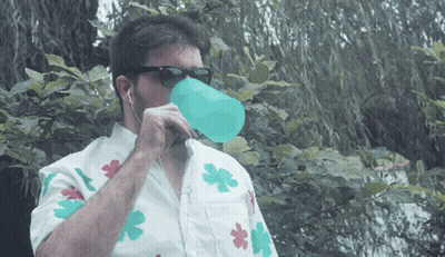 Man In Sunglasses And Flower Shirt Drinking From Blue Cup GIF