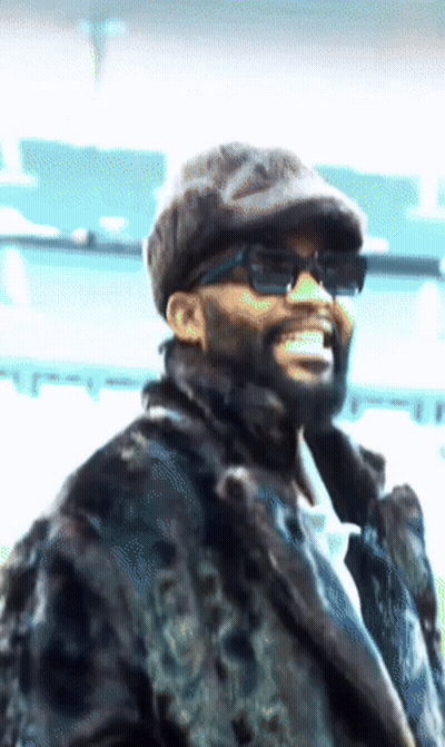 Man In Sunglasses And Fur Coat Smiling GIF