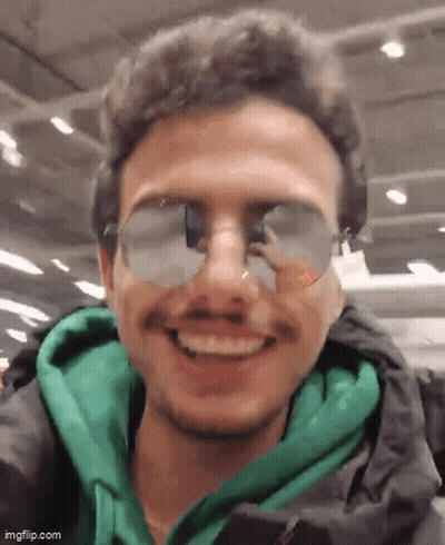 Man In Sunglasses And Green Jacket Smiling GIF