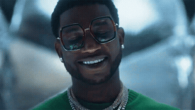 Man In Sunglasses And Green Sweater Smiling GIF