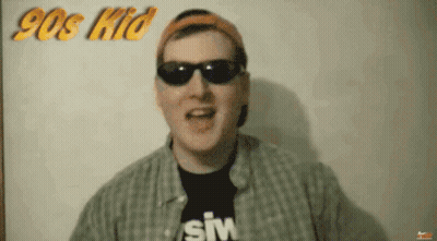 Man In Sunglasses And Hat In Front Of 90S Kid Sign GIF