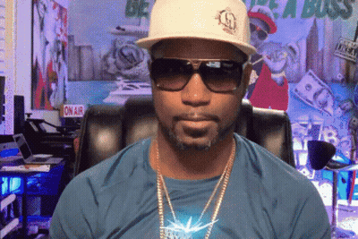 Man In Sunglasses And Hat In Front Of On Air Sign GIF