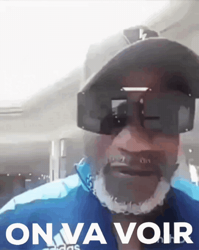 Man In Sunglasses And Hat Saying On Va Voir GIF