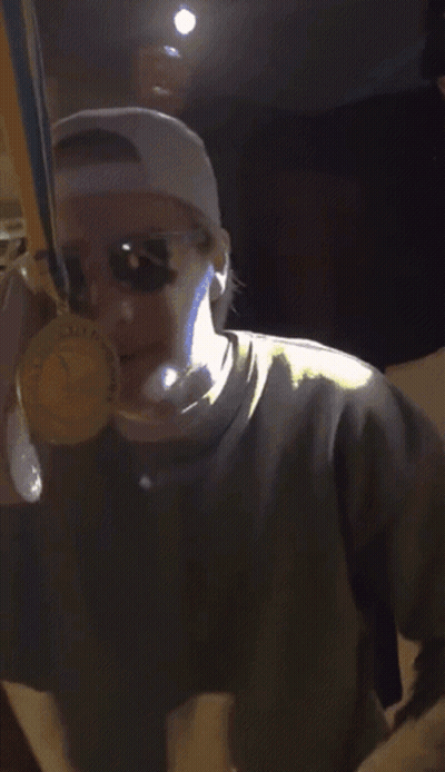 Man In Sunglasses And Hat Smiling Holding Something GIF