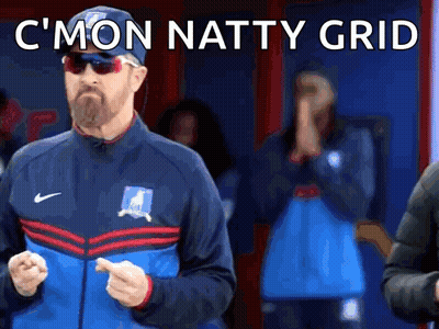Man In Sunglasses And Hat Standing In Front Of Crowd GIF