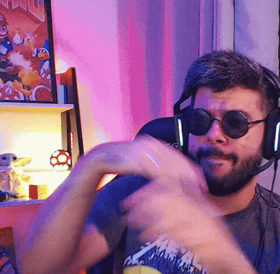 Man In Sunglasses And Headphones In Front Of Mario Poster GIF