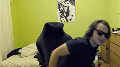 Man In Sunglasses And Headphones Sitting In Bedroom GIF