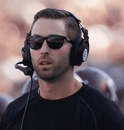 Man In Sunglasses And Headphones With Microphone Standing In Front Of Crowd GIF