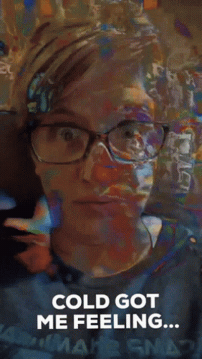 Man In Sunglasses And Hooded Jacket In Front Of Snowy Mountain GIF