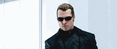 Man In Sunglasses And Leather Glove Holding Gun GIF