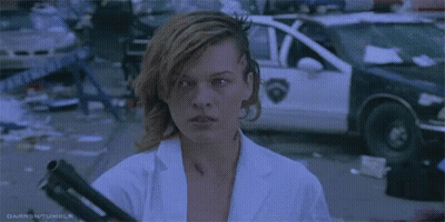 Man In Sunglasses And Leather Gloves Standing In Front Of Woman GIF