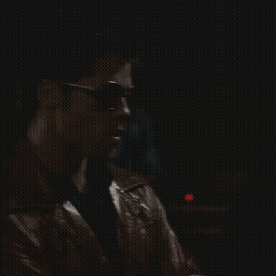 Man In Sunglasses And Leather Jacket Looking Left GIF