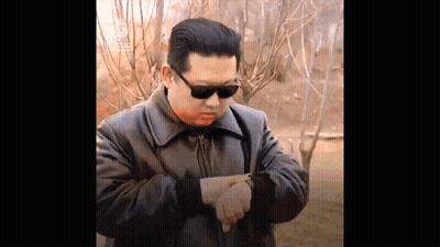 Man In Sunglasses And Leather Jacket Pointing At Watch GIF
