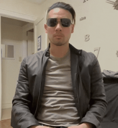 Man In Sunglasses And Leather Jacket With Clock Nine GIF