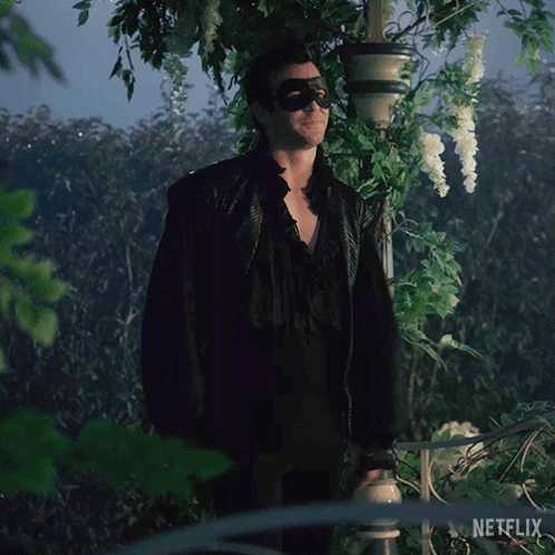 Man In Sunglasses And Mask In Front Of Netflix GIF