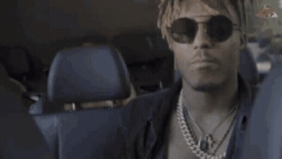 Man In Sunglasses And Necklace In Back Of Car GIF