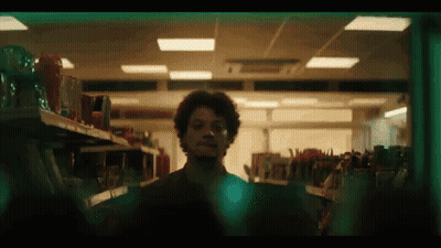 Man In Sunglasses And Orange Sweater Dancing In Front Of Fanta Sign GIF