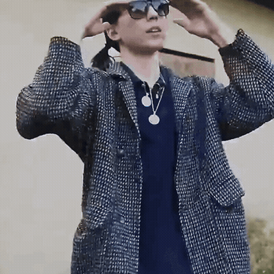 Man In Sunglasses And Plaid Jacket Covering Ears GIF