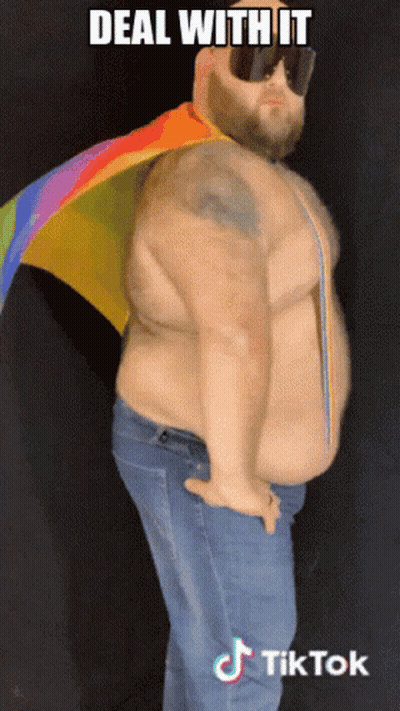 Man in Sunglasses and Rainbow Cape Saying Deal With It