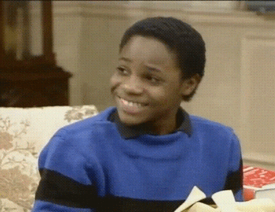 Man In Sunglasses And Red Jacket Making Funny Face On Couch GIF