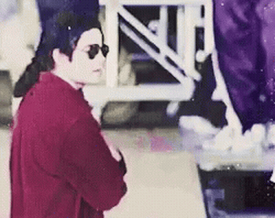 Man In Sunglasses And Red Shirt In Front Of Purple Staircase GIF