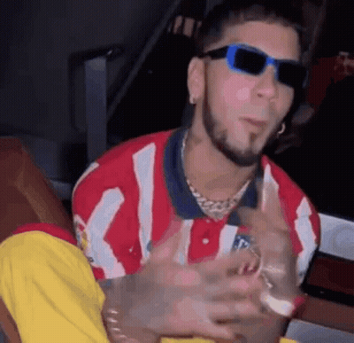 Man In Sunglasses And Red White Striped Shirt Sitting Down GIF