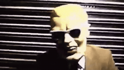 Man In Sunglasses And Suit By Striped Wall GIF