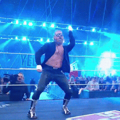 Man In Sunglasses And Suit Dancing In Wrestling Ring GIF