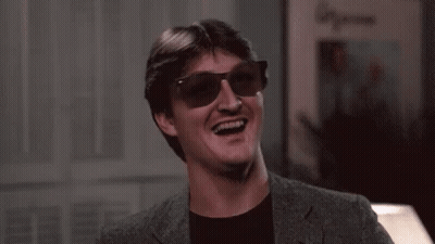 Man In Sunglasses And Suit Laughing And Smiling GIF